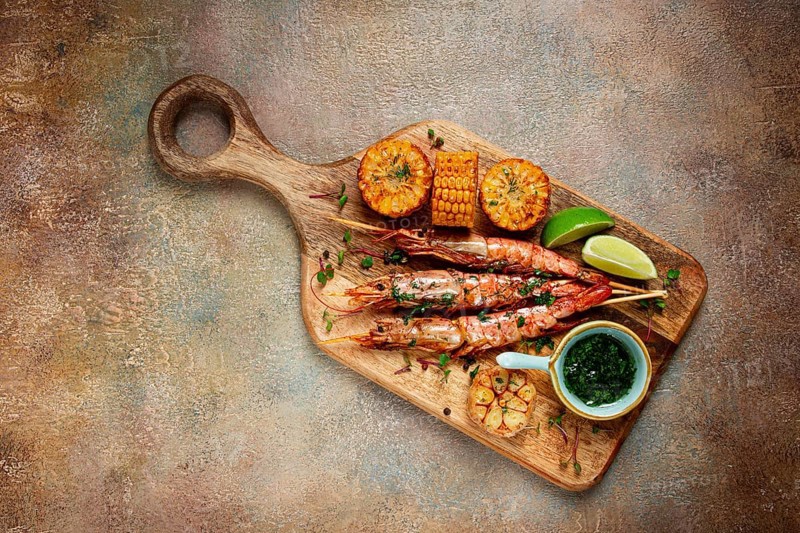 Langoustines on skewers, shrimp kebab, with fried corn, spices and herbs, homemade, no people