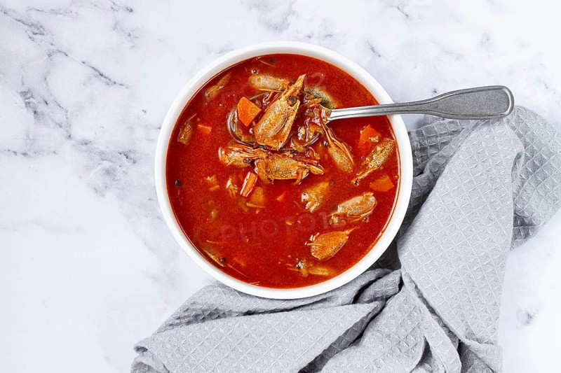 French shrimp bisque soup, on a marble table, close-up, no people