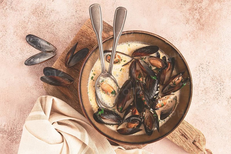 Mussels in creamy garlic sauce, served with fresh herbs and spices, homemade, no people
