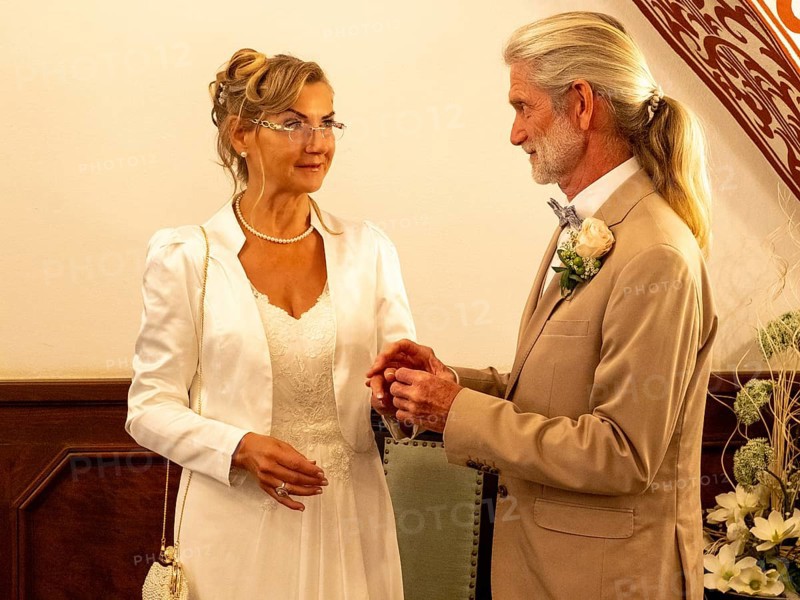 Elderly couple's wedding, registry office, attach rings