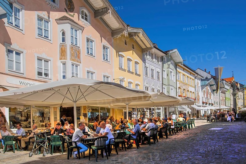 Historic market street with street cafe and typical gabled houses, Bad Tölz. Isartal, Upper Bavaria, Bavaria, Germany