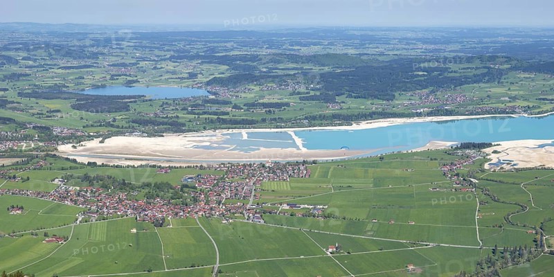 Panorama in spring from Tegelberg, 1881m, of Schwangau, Waltenhofen, Hopfensee and the partly still drained Forggensee, Ostallgäu, Bavaria, Germany