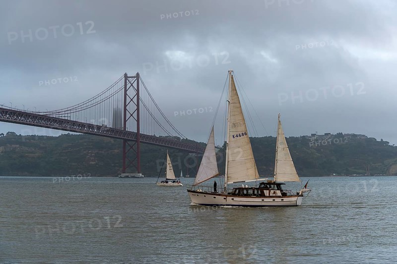 The Ponte 25 de Abril, 3.2 km long bridge in Portugal with a 2278 meter long suspension bridge across the Tagus, cloudy and rainy weather, third-longest suspension bridge with combined road and rail traffic, Lisbon, Portugal