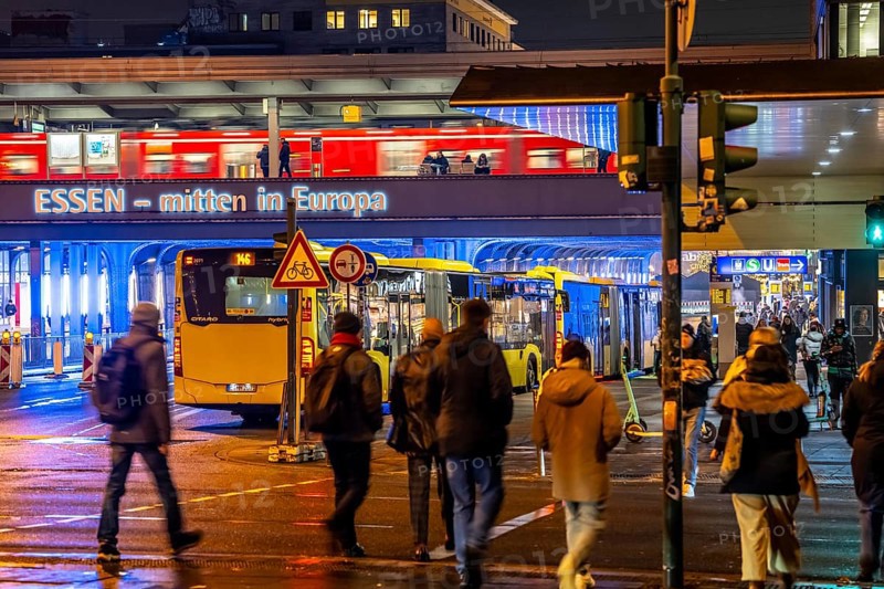 The main train station in Essen, blue illuminated underpass, bus station, am Europaplatz, train on the platform, pedestrian crossing, North Rhine-Westphalia, Germany