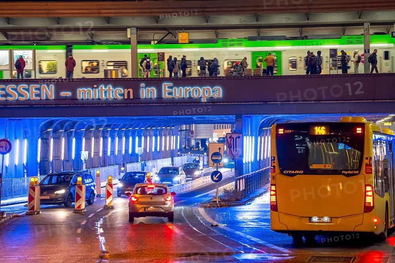 The main train station in Essen, blue illuminated underpass, bus station, am Europaplatz, train on the platform, North Rhine-Westphalia, Germany