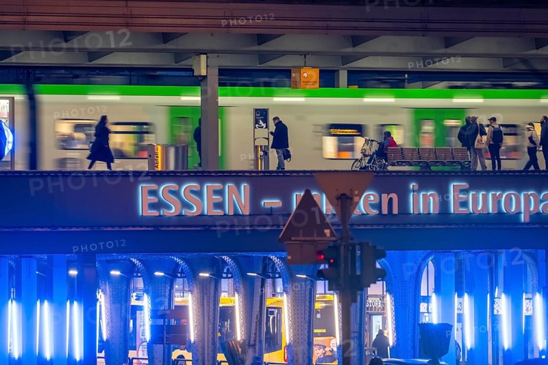 The main train station in Essen, blue-lit underpass, bus station, am Europaplatz, public transport train on the platform, North Rhine-Westphalia, Germany