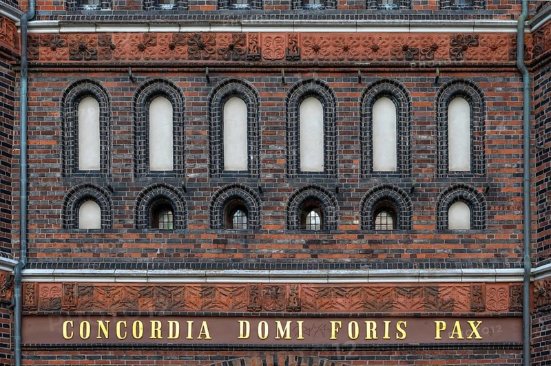 Concodia Domini Fotris Pax: The harmony of the Lord, the peace of the father, a saying at the Holsten Gate, historic city gate from 1478, Holstentorplatz, Hanseatic City of Lübeck, Schleswig-Holstein, Germany