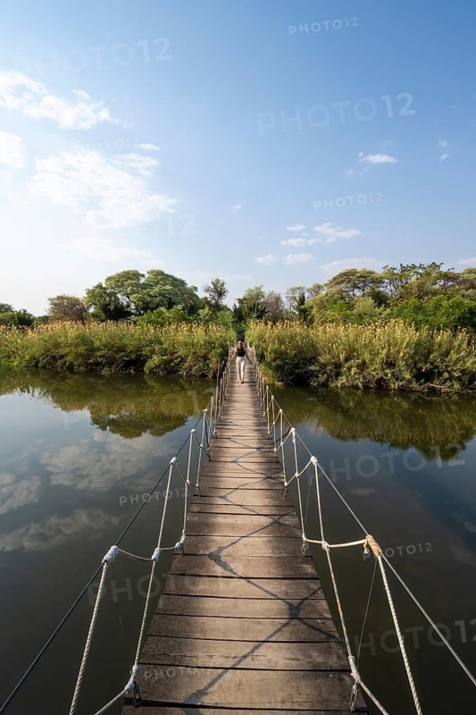 Toruist on the Kavango River, suspension bridge at Camp Kwando, Zambezi region, Caprivi Strip, Namibia