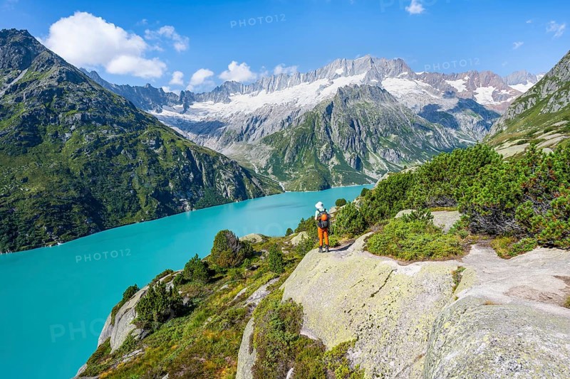 Mountaineers in front of picturesque mountain landscape, turquoise-blue mountain lake Göscheneralpsee, Dammastock and Damma Glacier, Göscheneralp, Canton of Uri, Switzerland