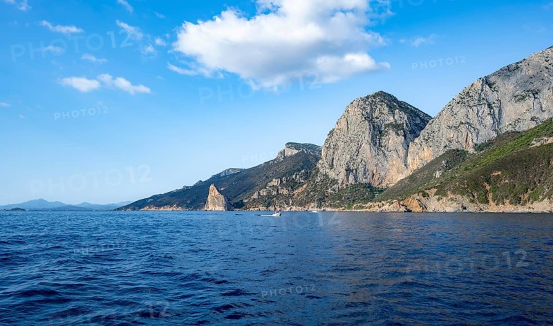 Picturesque rocky coast, cliffs with Pedra Longa pinnacle, blue sea, Golfo di Orosei, Baunei, Sardinia, Italy