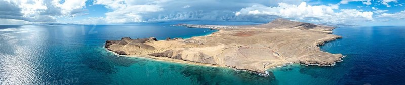 Headland and blue sea, coastal landscape, arid landscape of Los Ajaches Natural Park, aerial view, Lanzarote, Canary Islands, Spain