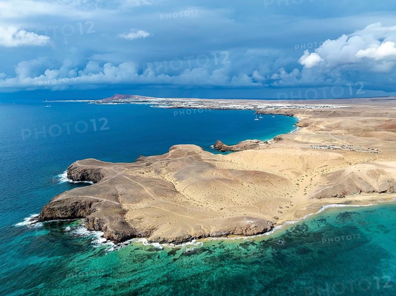 Coast with Playa de Papagayo beach and Playa Caleta del Congrio and blue sea, dry landscape of Los Ajaches Natural Park, aerial view, Lanzarote, Canary Islands, Spain