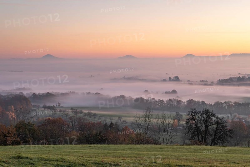 Three Kaiserberge mountains in golden morning light, Hohenstaufen, Aichelberg. Spectacular dawn over the foggy foothills of Baden-Württemberg