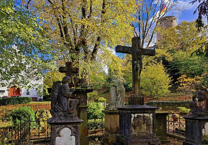 Old tombs at the castle cemetery at St. Michael's Chapel with the Godesburg, Bad Godesberg, Bonn, North Rhine-Westphalia, Germany