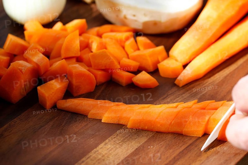 Southern German cuisine, preparing vegetables, cutting raw carrots, celery, onions, vegetarian, vegan, healthy, knife, cutting board, men's hand, traditional cuisine, food photography, studio, Germany
