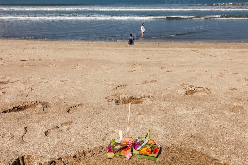 Canang Sari is a Balinese offering that expresses Wasa (God) or the creators of life to Sang Hyang Widhi. The offerings are used to balance and maintain peace on earth, between good and evil, between gods and demons, between heaven and hell, Kuta beach, Bali, Indonesia
