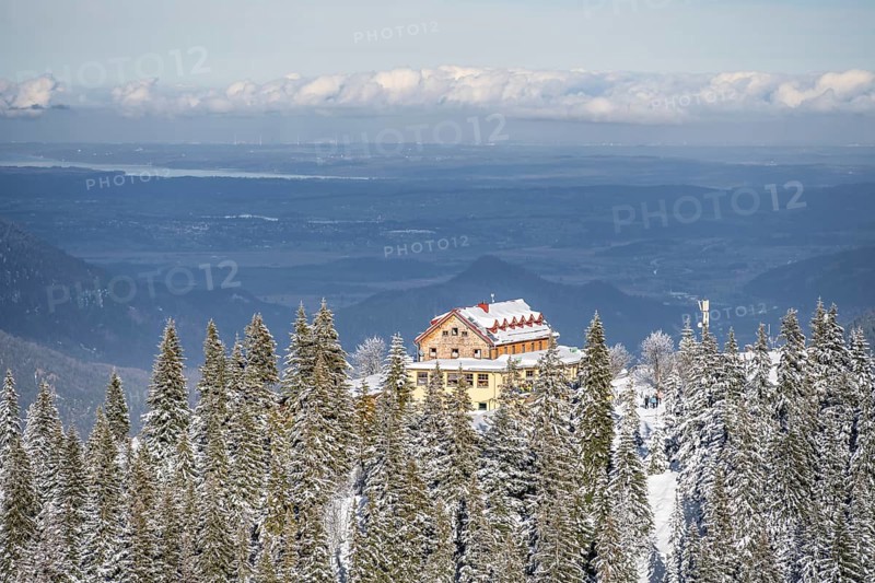 Snowy forest and Kreuzeckhaus mountain hut in the Garmisch Classic ski area in winter, Wetterstein Mountains, Garmisch-Partenkirchen, Bavaria, Germany