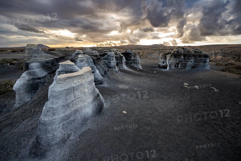 Eroded rock formations, volcanic landscape with dramatic cloudy sky at sunset, Ciudad Estratificada or Los Roferos, Antigua Rofera de Teseguite, Lanzarote, Canary Islands, Spain