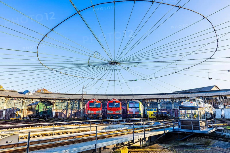 Turntable and overhead line spider, behind it modern locomotives of the Austrian Federal Railways, ÖBB, and Deutsche Bahn, DB, parked in front of the old lock shed, Augsburg railway park, administrative district of Swabia, Bavaria, Germany