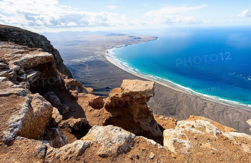 View from the Risco de Famara Cliff to Famara Beach, Playa de Famara with La Calaeta, Lanzarote, Canary Islands, Spain