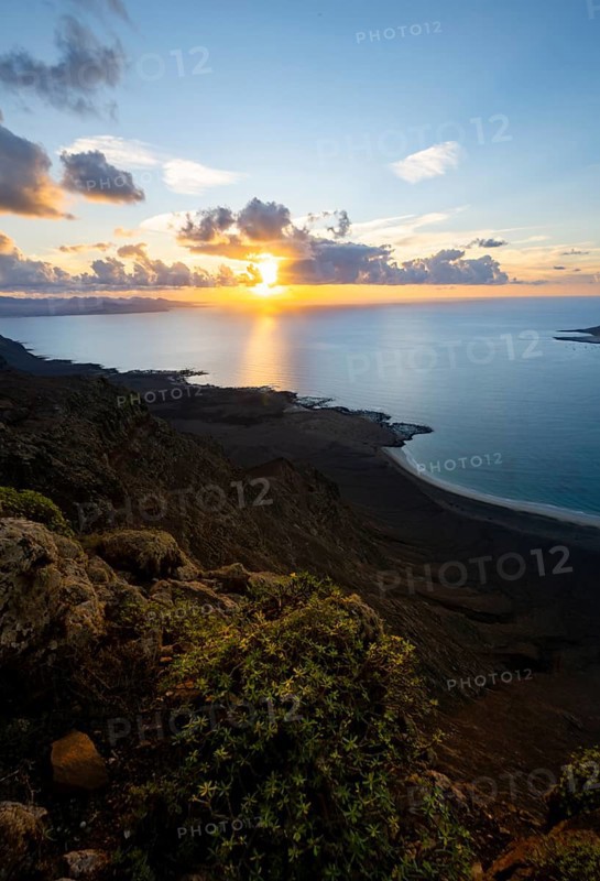 View of steep cliffs on sea and coast, Mirador del Porrito viewpoint at sunset, Lanzarote, Canary Islands, Spain