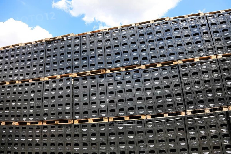 Stacked black beer crates from the Kulmbacher Group, a beverage manufacturer that includes Kulmbacher Brauerei AG and other breweries such as Sternquell, Braustolz and Würzburger Hofbräu, editorial