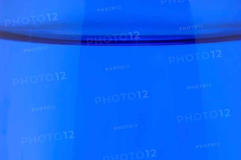 Glass with mineral water, small carbonated pearls on the edge of the glass, drinking water