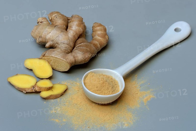 Ginger root and ginger powder in spoon, Zingiber officinale