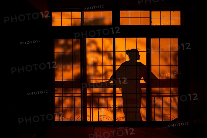Shadows of a woman in kimono, on the balcony behind sliding shoji doors in a traditional Japanese house, Yamanouchi, Nagano, Japan