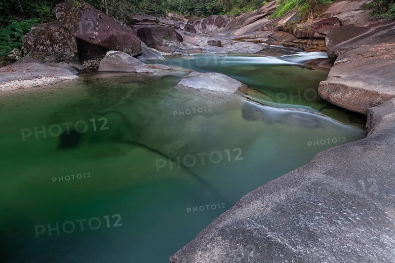 Turquoise blue water between rocks in the tropical rainforest of Babinda Boulders Queensland Australia