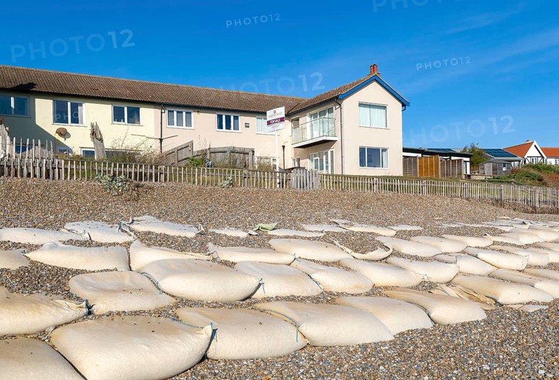 For Sale estate agent signs outside houses at risk of coastal erosion, Thorpeness, Suffolk, North Sea coast, England, UK October 2025