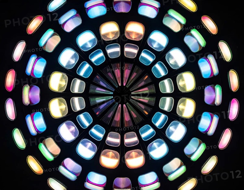 Abstract background of slightly unfocused multicolored glass lenses spinning and rotating, wallpaper illustration in vibrant neon colors, mandala background for business, textures and pattern, AI generated