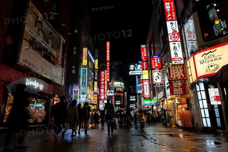 Busy pedestrian zone with many shopping centers and stores, illuminated with lots of neon signs at night, Shibuya, Udagawacho, Tokyo, Japan