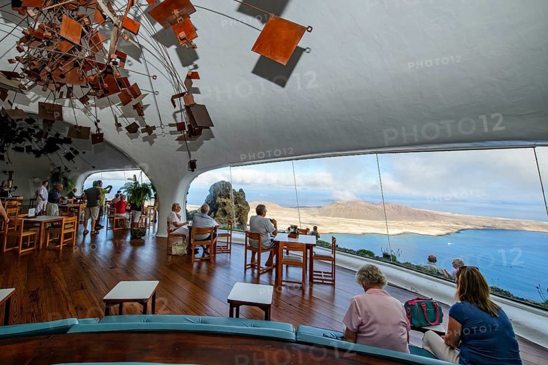 Interior of café with panoramic window in building designed by Cesar Manrique with the collaboration of Jesús Soto and architect Eduardo Caceres without right angles corners on viewpoint tourist attraction El Mirador del Río on the summit of the 474 meter high Risco de Famara in Famaramassiv with panoramic view of the Chinijo Archipelago, La Graciosa island, Lanzarote, Canary Islands, Canary Islands, Spain