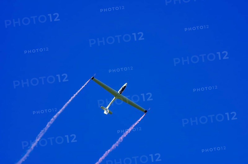 An SZD-59-1 ACRO glider, registration D-1138, during a demonstration as part of an air show at the Fliegerbergfest of the Rossfeld Luftsportverein in Metzingen-Glems, Baden-Württemberg, Germany, for editorial use only