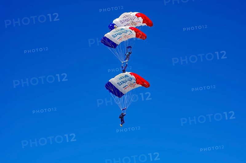 Skydivers during an aerial acrobatic performance as part of an air show at the Fliegerbergfest of the Rossfeld Luftsportverein in Metzingen-Glems, Baden-Württemberg, Germany, for editorial use only
