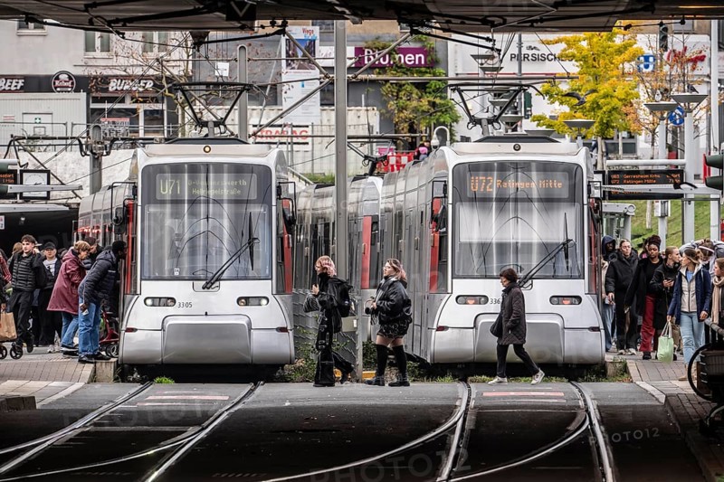 Pedestrians cross the tram tracks, at Düsseldorf-Bilk station, junction of S-Bahn, subway, tram, local bus transport, North Rhine-Westphalia