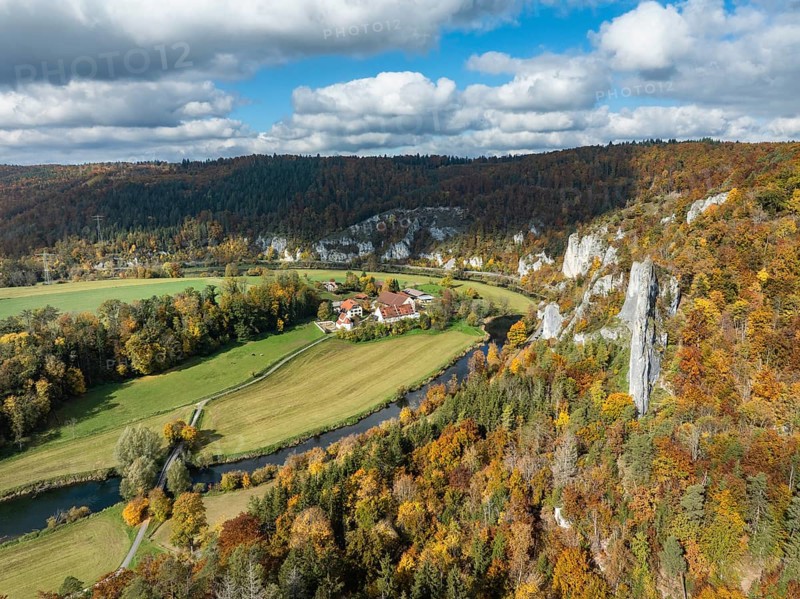 Aerial view of Käppeler Manor with St. George's Basilica near Thiergarten in the Upper Danube Valley, surrounded by autumn vegetation, on the right the raven rocks, climbing rocks, Jura limestone rocks, Sigmaringen district, Baden-Württemberg, Germany