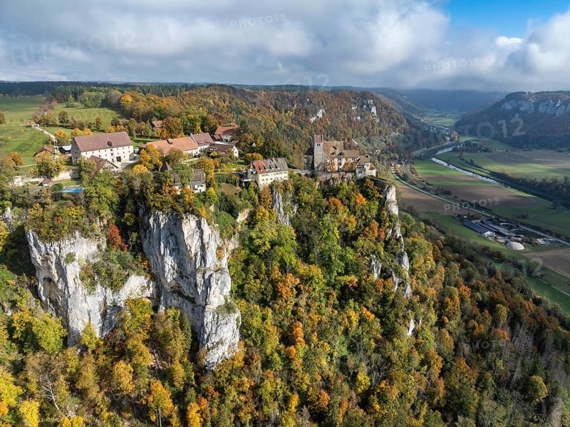 Aerial view of Werenwag Castle and former Werenwag Castle on a rocky spur in the Upper Danube Valley, surrounded by autumnal vegetation and clouds of fog, Sigmaringen district, Baden-Württemberg, Germany