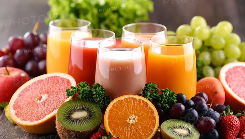 Fresh fruit juices in glasses, surrounded by colorful fruits, showcasing healthy drinking and eating, fitness and wellness lifestyle, AI generated