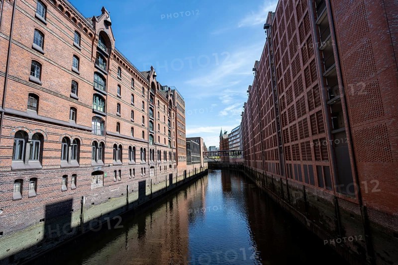 Canal between red brick buildings, warehouses in Hamburg's Speicherstadt, Hamburg, Germany