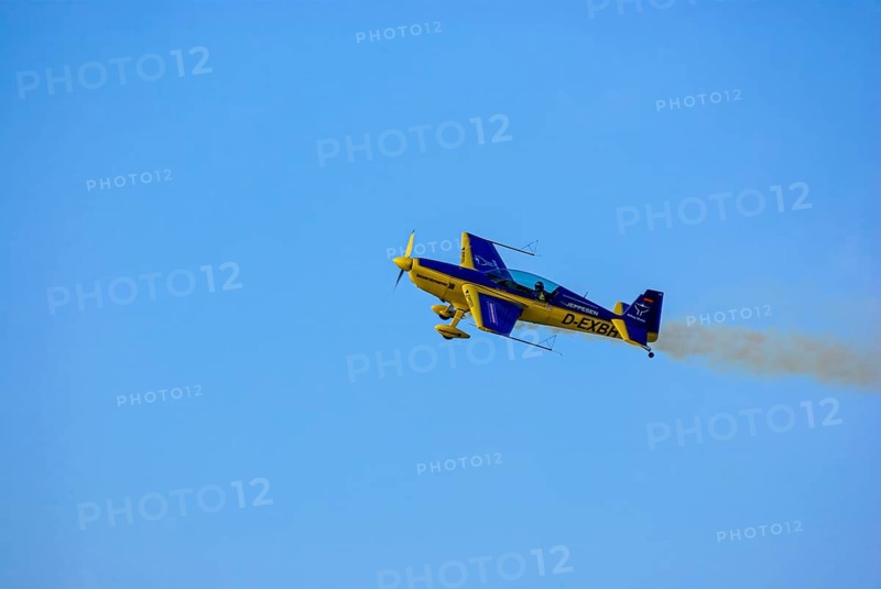 An Extra EA-300 of Extra Flugzeugproduktions- und Vertriebs GmbH with the registration D-EXBH during a flight demonstration as part of an air show at the Rossfeld in Metzingen-Glems, Baden-Württemberg, Germany, for editorial use only
