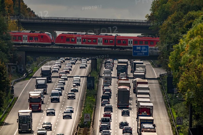 Local train crossing the A3 motorway between the Hilden junction and the Mettmann junction, view to the south, traffic jam due to construction work, North Rhine-Westphalia, Germany