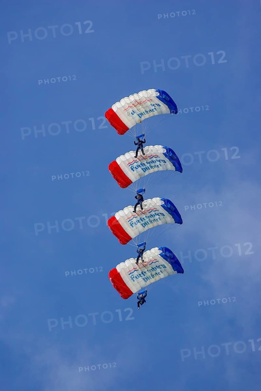 Parachutists during an aerial acrobatic demonstration as part of an air show on the Rossfeld in Metzingen-Glems, Baden-Württemberg, Germany, for editorial use only