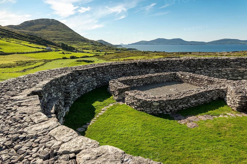 Stone walls of the Loher Stone Fort ring fort near Caherdaniel overlooking green pastures and the sea, Ring of Kerry, Iveragh Peninsula, County Kerry, Ireland