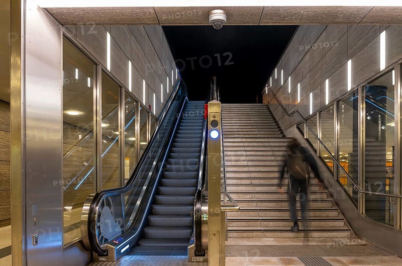 Night photo, long exposure with motion blur, modern underground entrance at Unter den Linden station, contemporary design with stairs and escalator, Berlin, Germany