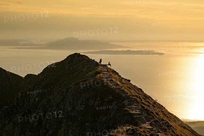 Hikers on the Rørsethornet stone staircase, with 3292 steps one of the longest continuous stone staircases in the world, Sherpatreppe or Midsundtreppe or Midsundtrappene, Rørsethornet hike, evening mood, Otroya or Otrøya island, Møre og Romsdal, Norway