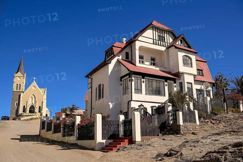 Colonial house facade in the Kirchstraße, in the background the rock church, Lüderitz, Karas region, Namibia
