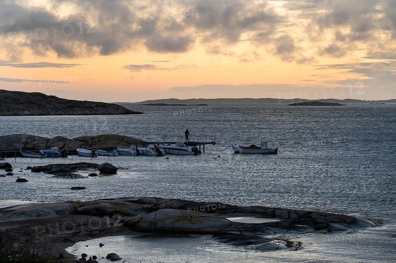 Small bay, archipelago, jetty with angler, Resö Island, Bohuslän, Skagerrak, Sotenäs, Västra Götalands län, Sweden