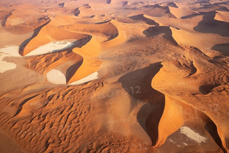 Sand dunes and dry pans in the Namib Desert. In the evening. Aerial view. Namib-Naukluft Park, Namibia